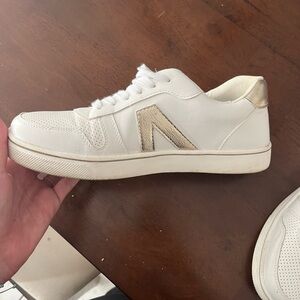 Women’s white and gold sneakers